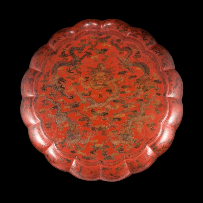 This is a large polychrome lacquer box of the Qianlong period (1735-1796) carrying clear imperial attributes. With five five-clawed dragons on the top and more of them, ascending and descending, on the 16 lobes. There is a similar box in the Shenyang Palace Museum. Presented by Binnenweg antiques dealer.