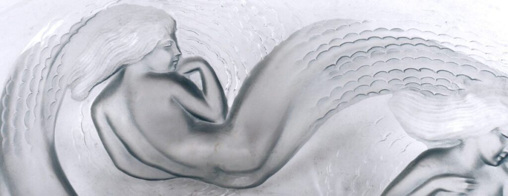 A mermaid from a 1932 Calypso bowl by René Lalique. Clear glass with a blue grey patina.
