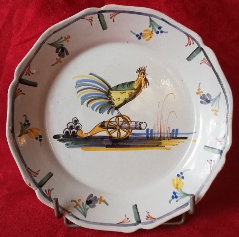 The rooster of the French nation is watching to defend it against opposing forces. On a Nevers or Auxerre revolutionary faience plate.