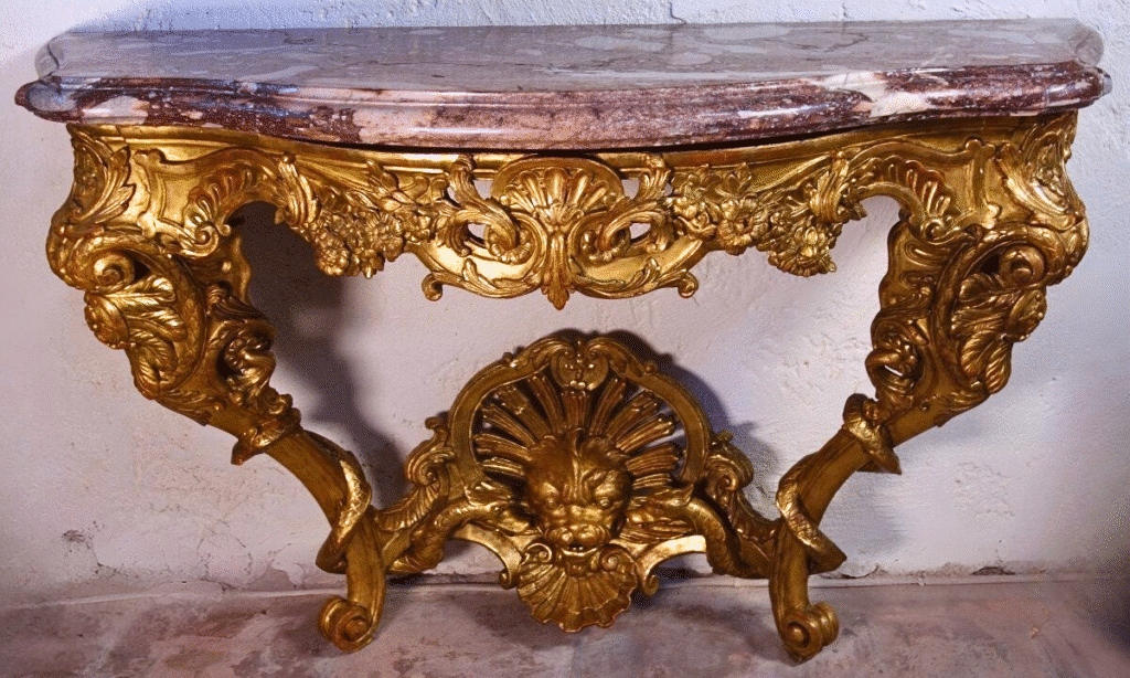 18th-century console in carved gilt wood attributed to Bernard Toro. Highly ornated with dragons, acanthus leaves and scrolls. Violet breccia marble top.