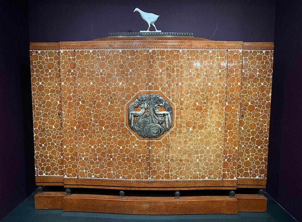 This cabinet known as "Bahut Élysée" by Ruhlmann was delivered to the French presidential palace in 1926. It was created in 1920 and was one of the Ruhlmann pieces exhibited at the historic 1925 Decorative Arts Fair in Paris. It features varnished amboyna burl marquetry with ivory inlays, constructed on an oak carcass. 