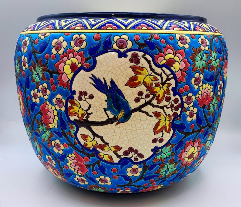 A striking 19th-century Longwy planter with a D5670 decor and a blue jay.