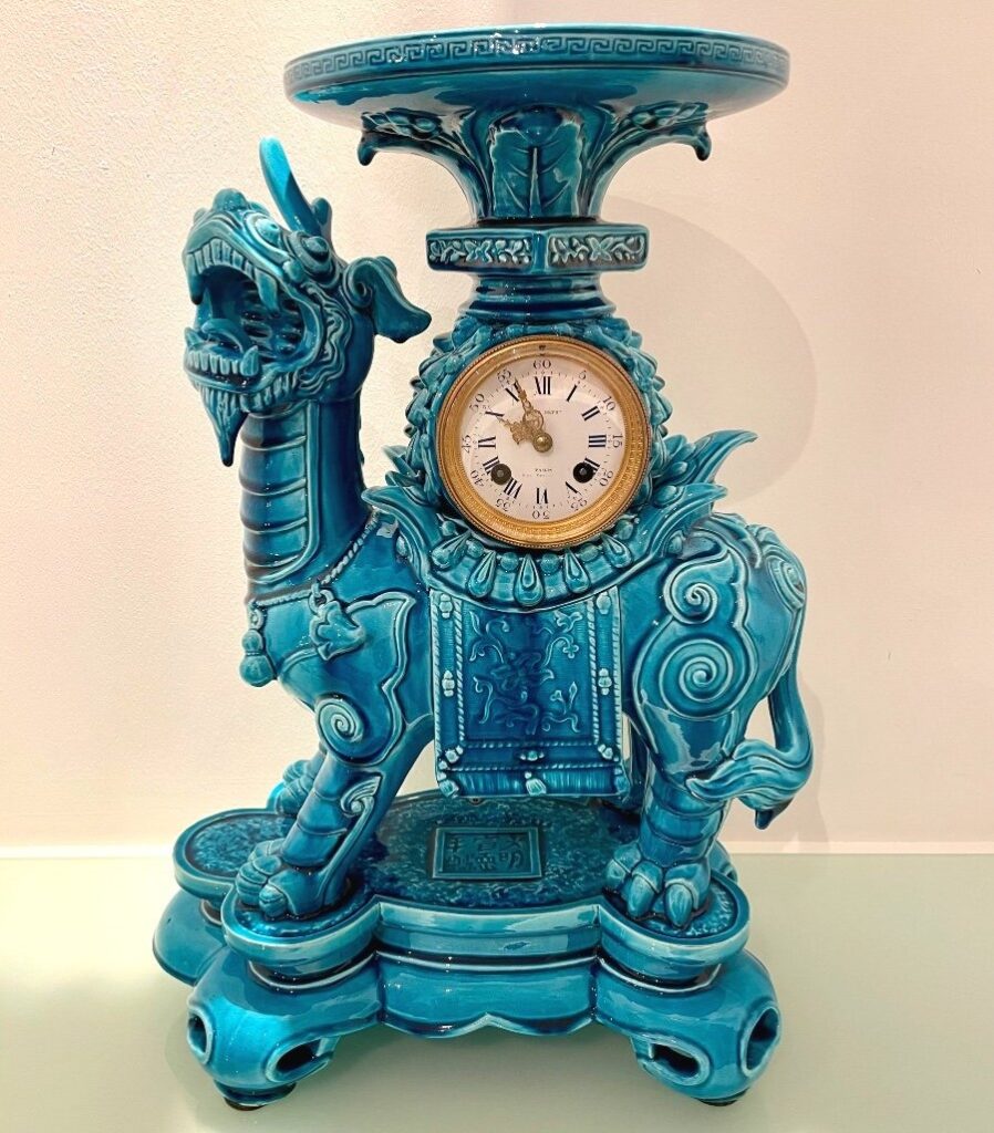 This unicorn dragon in a striking "Théodore Deck" turquoise blue is characteristic of Longwy production inspired by a fantasized Orient. Incense burner in the upper section. Clock in working order.