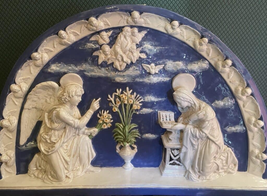 A 19th-century glazed terracotta plaque inspired by the Annunciation by Andrea Della Robbia in Florence's Ospedale degli Innocenti.