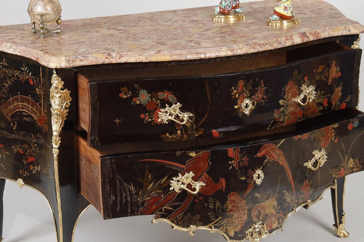 An 18th-century chest of drawers with polychrome European lacquer decoration, in blue, red, and gold on a black background. Typical of Mathieu Criaerd for the lacquer, the rich gilt bronze decoration, the trim and apron.