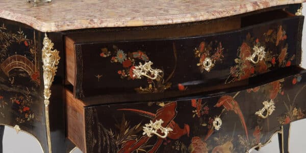 An 18th-century chest of drawers with polychrome European lacquer decoration, in blue, red, and gold on a black background. Typical of Mathieu Criaerd for the lacquer, the rich gilt bronze decoration, the trim and apron.