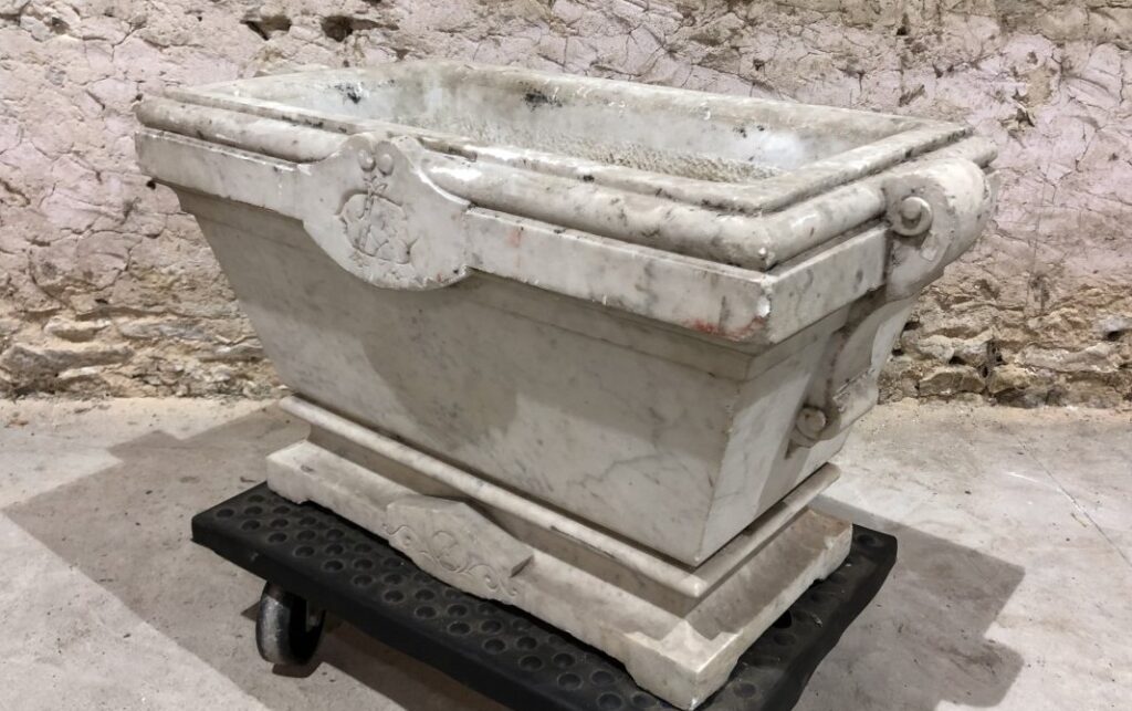 18th-century sculpted and monogrammed marble planter with a zinc-lined base.