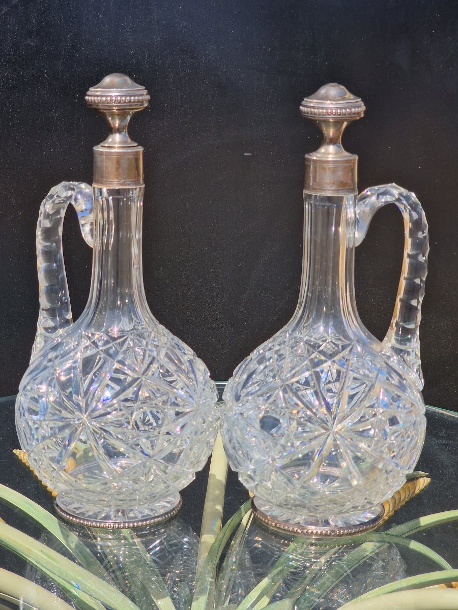 Pair Of Baccarat Crystal Ewers With Solid Silver Bases; Minerve-style Wine And Water Carafes
