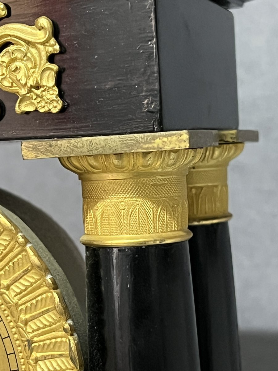 Empire Clock With 4 Columns, Pendulum, In Blackened Wood With Mercury-gilt Bronzes.-photo-1