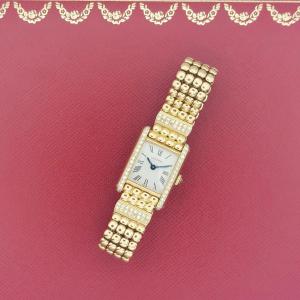 Montre Cartier Tank Louis Cartier mini, or jaune et diamants.