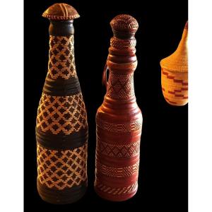 Reunion Of Two Old Bottles Covered In Braided Leather