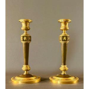 Paire de flambeaux d’époque Empire en bronze doré et patiné d’après Claude Galle. 