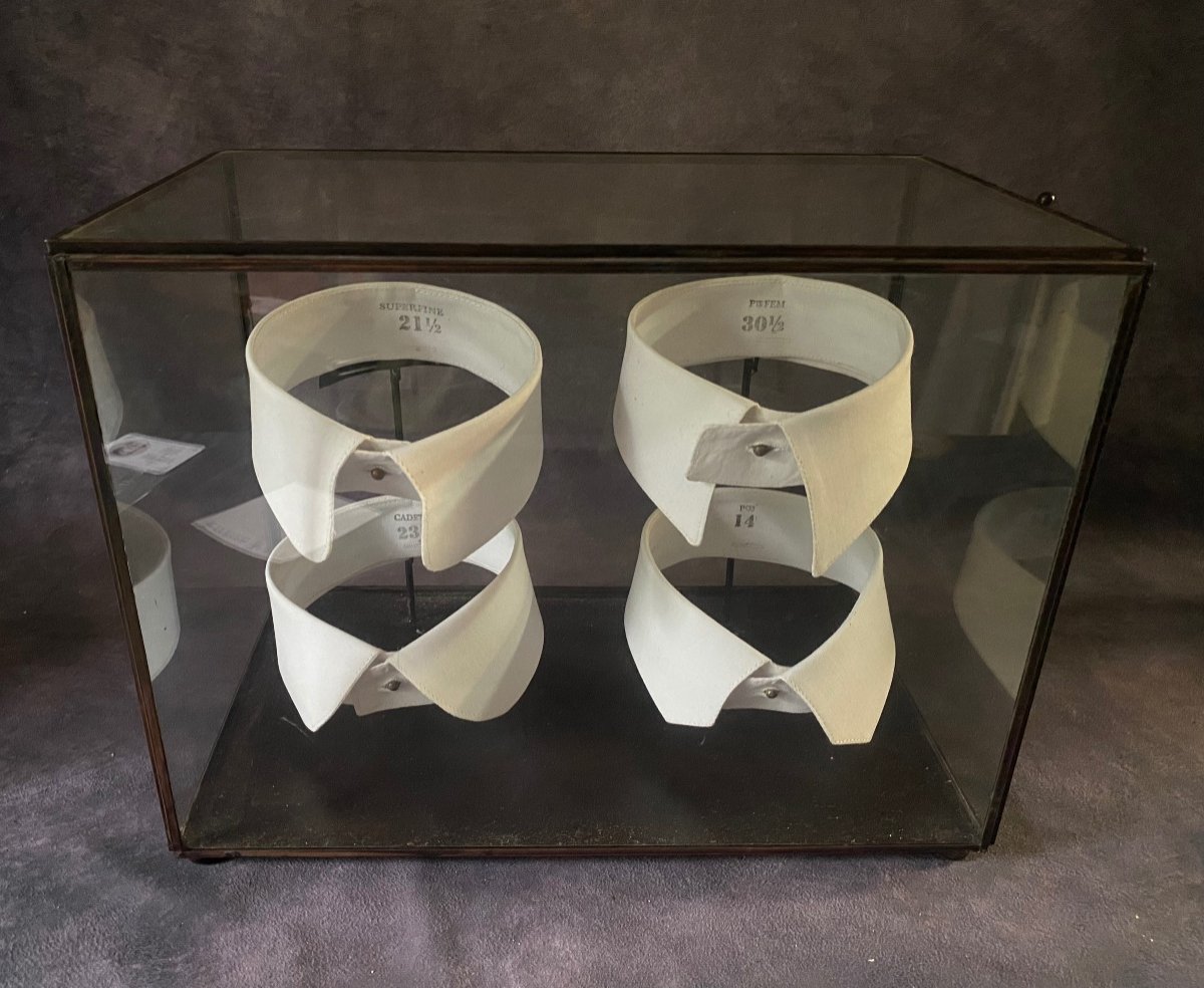 Vintage Glass And Iron Display Cabinet Containing A Series Of Shirt Collars.