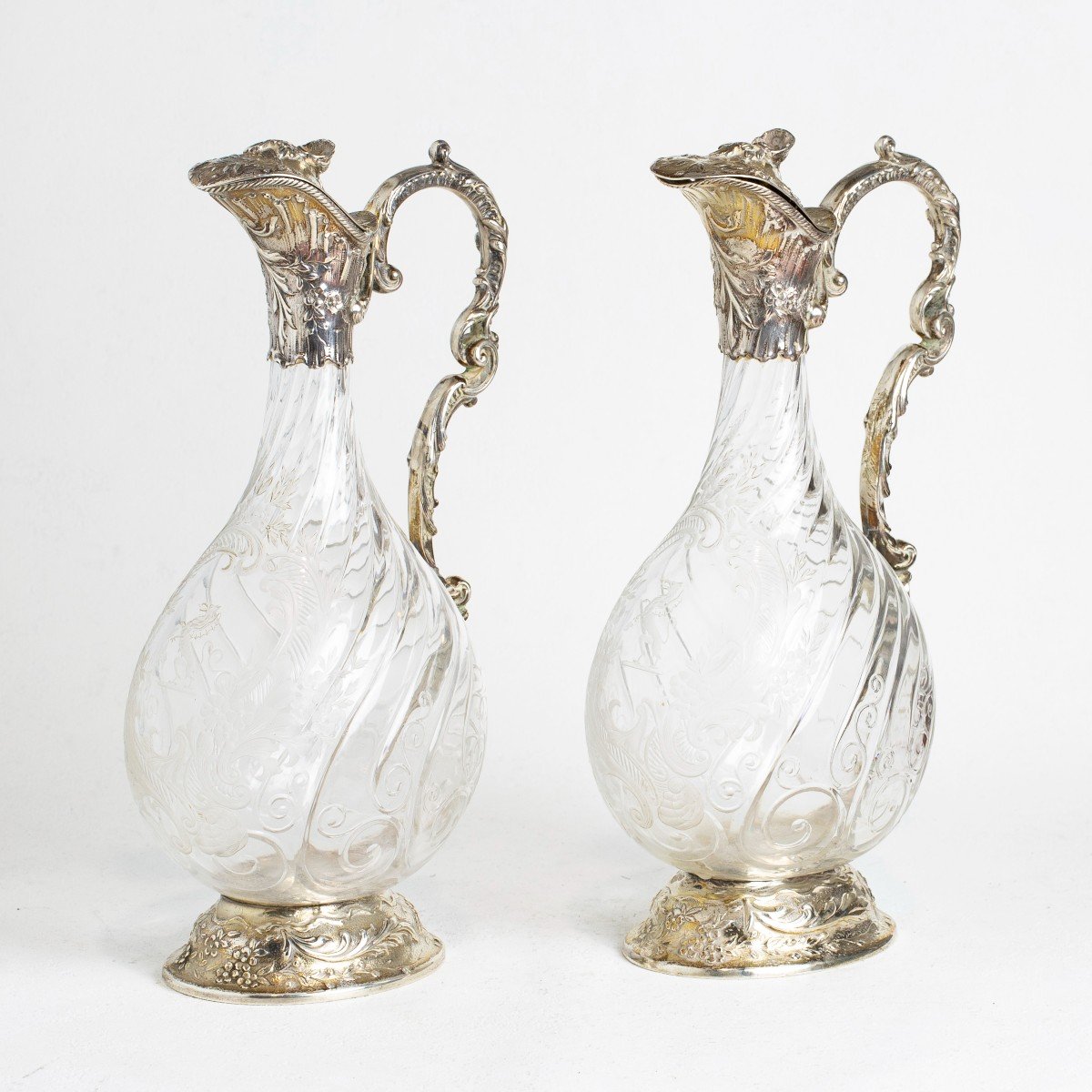 A Pair Of Silver And Cut Glass Claret Jugs