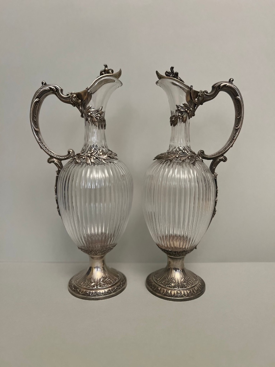 A Pair Of Silver And Cut Glass Ewers.