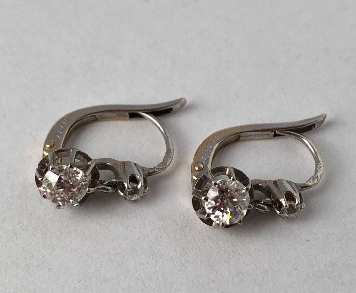 A Pair Of White Gold Earrings With Diamonds