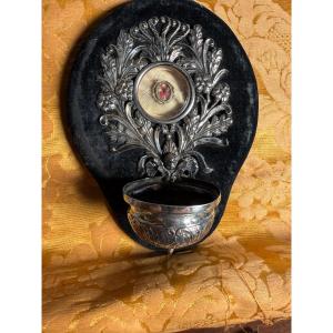 A Silver Embossed Holy Water Font Containing, At Its Center, The Relic Of The Holy Cross Of Our Lord Jesus Christ.