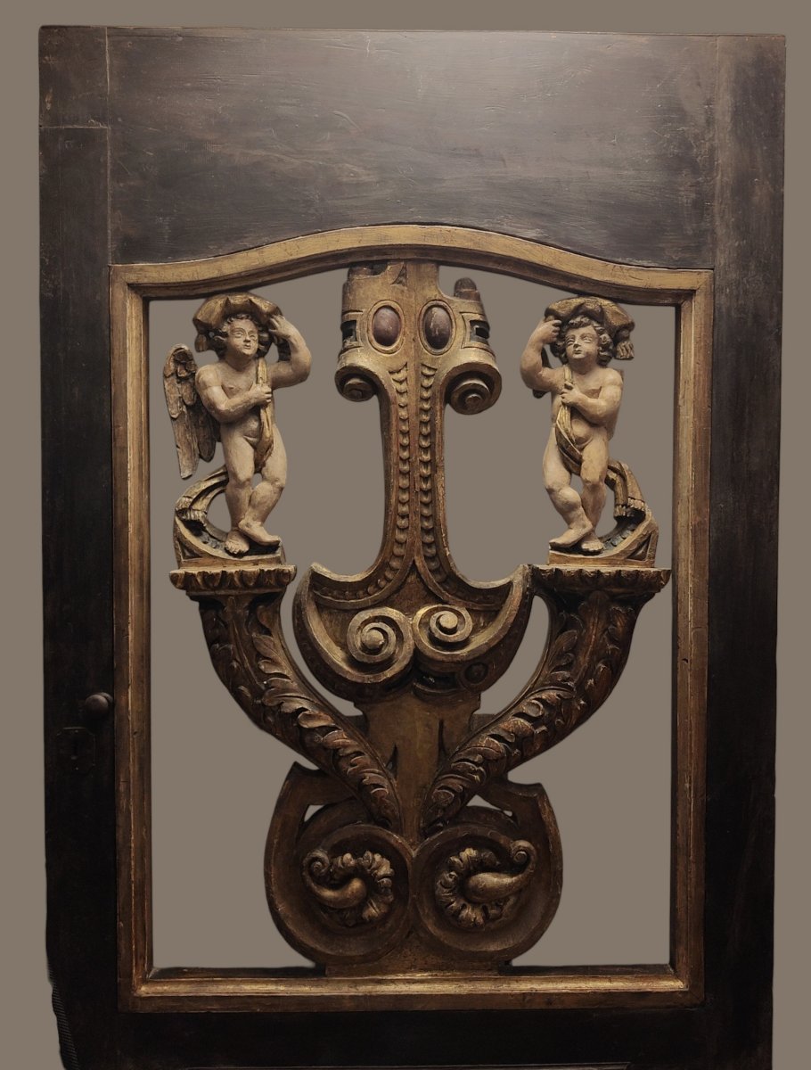 An Imposing Italian Door Adorned With Two Carved Putti
