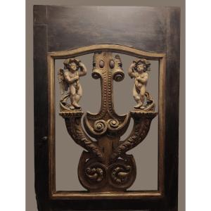 An Imposing Italian Door Adorned With Two Carved Putti