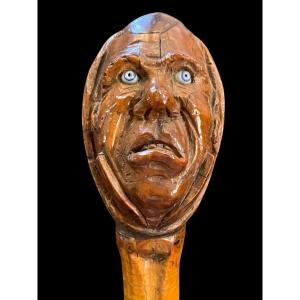 Stick With Curozo Seed Knob Depicting A Grotesque Face. Glass Eyes And Bamboo Cane. 