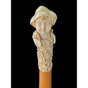 Stick With Ivory Knob Depicting A Bust Of A Young Man With A Hat. 