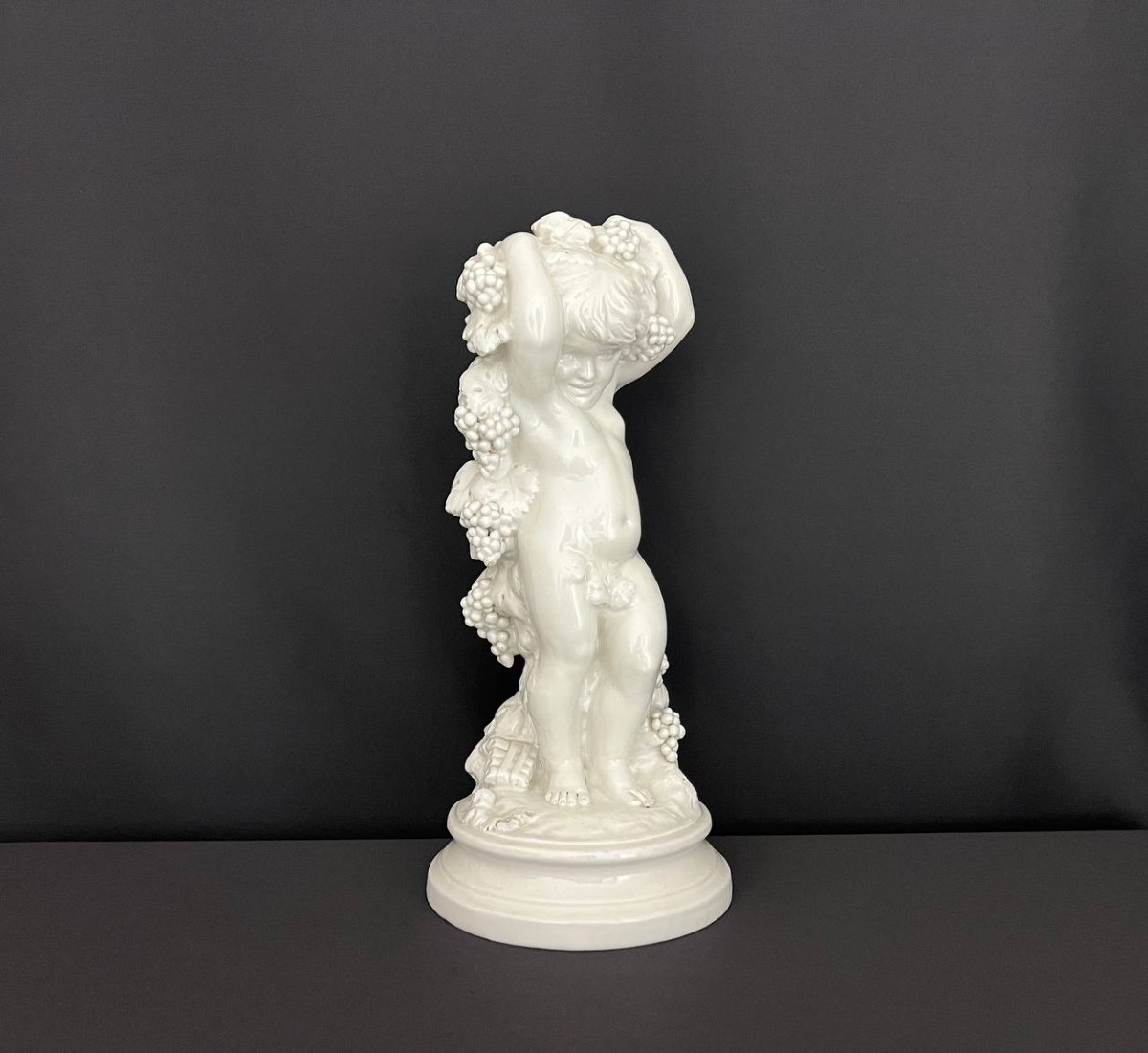 Capodimonte Statuette – Putto With Bunches Of Grapes – White Enameled Porcelain
