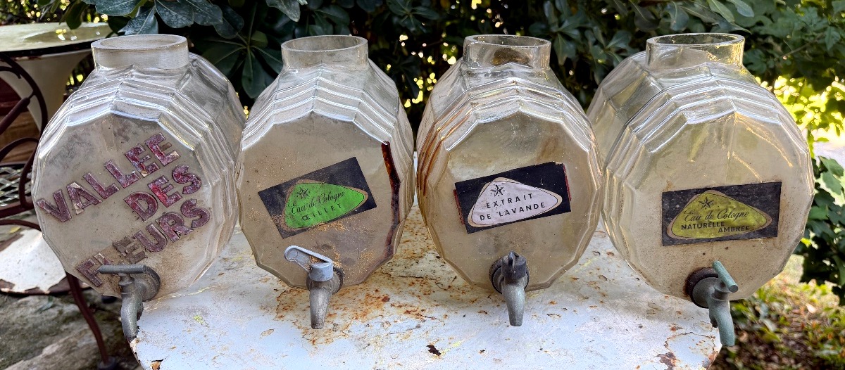  Ensemble de quatre caves à parfum: " tonneau" en verre moulé robinets d'étain ,des années "30"