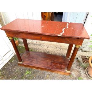 Sobre et élégante console 1er Empire en placage d'acajou pieds colonnes et marbre rouge griotte