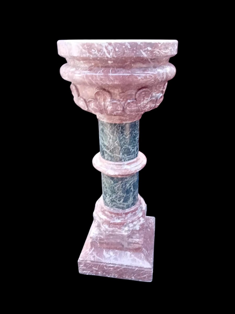 A Set Consisting Of Two Columns And A Marble Font.-photo-1