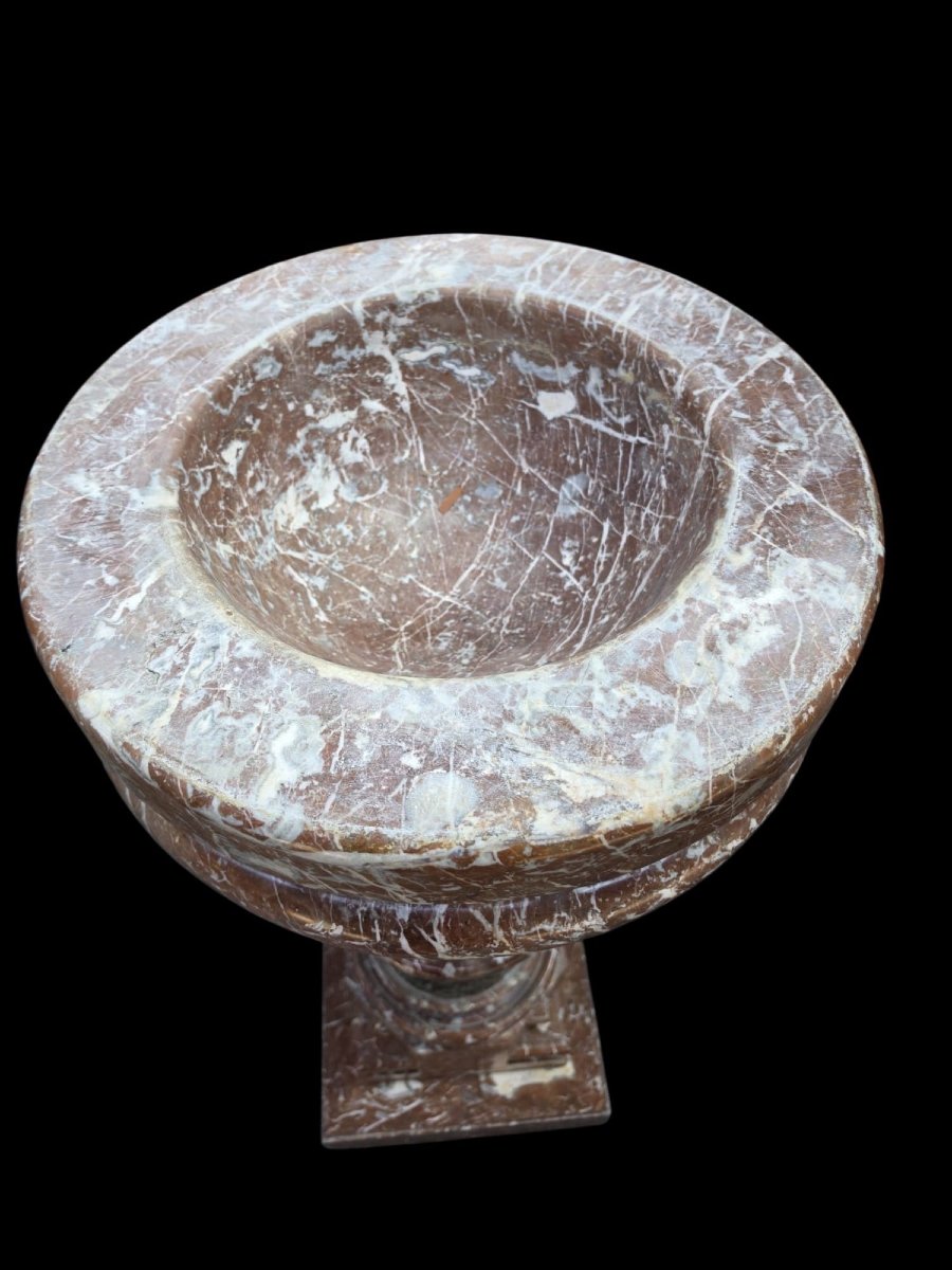A Set Consisting Of Two Columns And A Marble Font.-photo-6