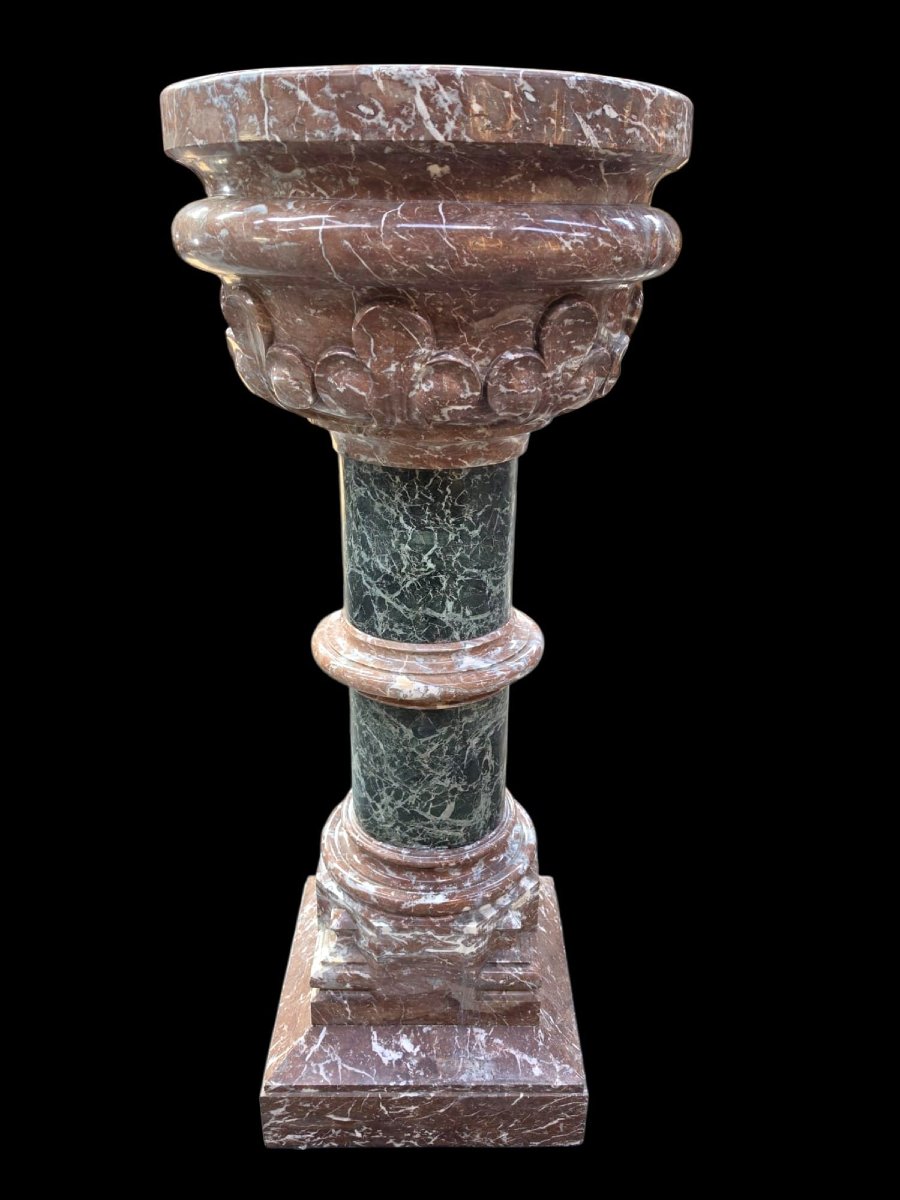 A Set Consisting Of Two Columns And A Marble Font.-photo-2