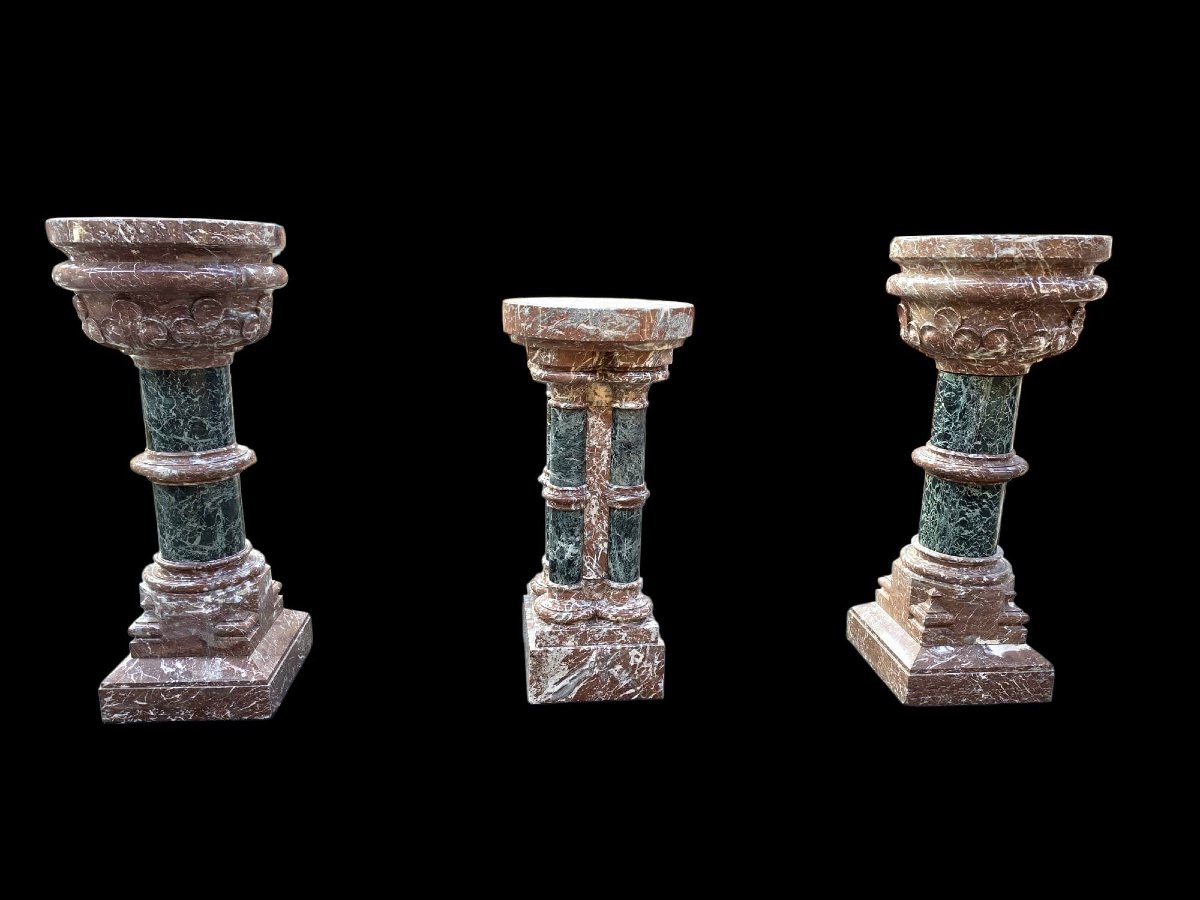 A Set Consisting Of Two Columns And A Marble Font.-photo-6