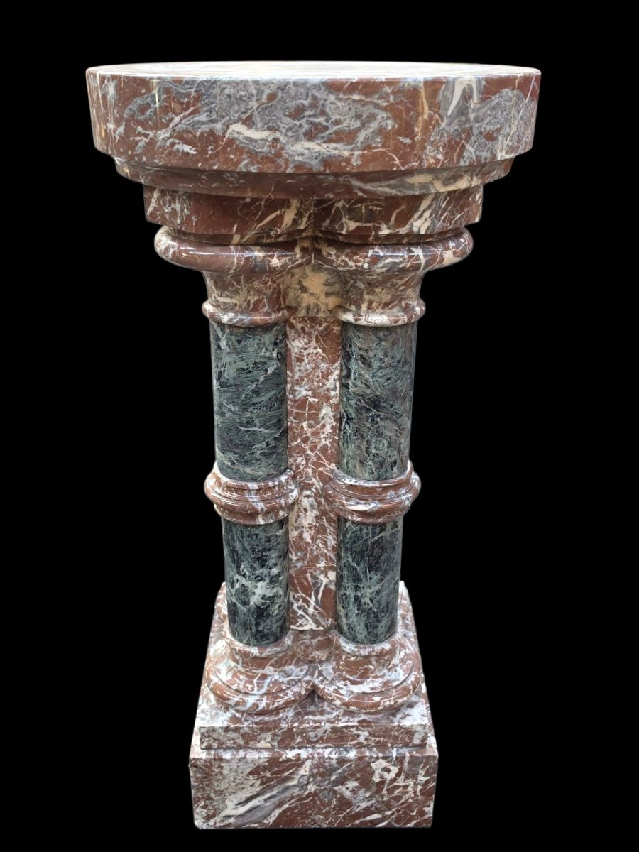 A Set Consisting Of Two Columns And A Marble Font.-photo-8