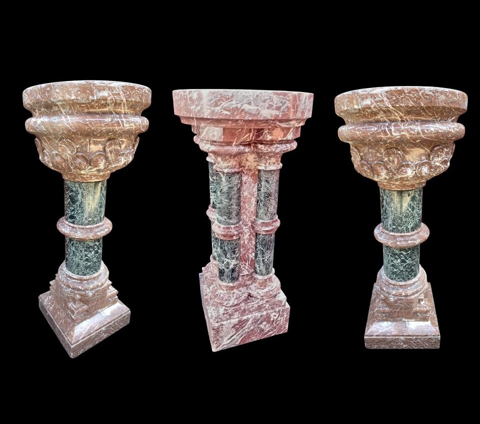 A Set Consisting Of Two Columns And A Marble Font.