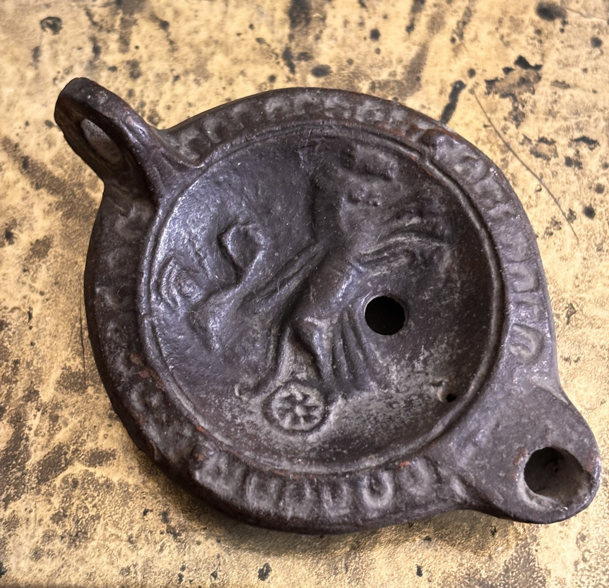 Lampe à huile romaine en terre cuite représentant un gladiateur ou un char