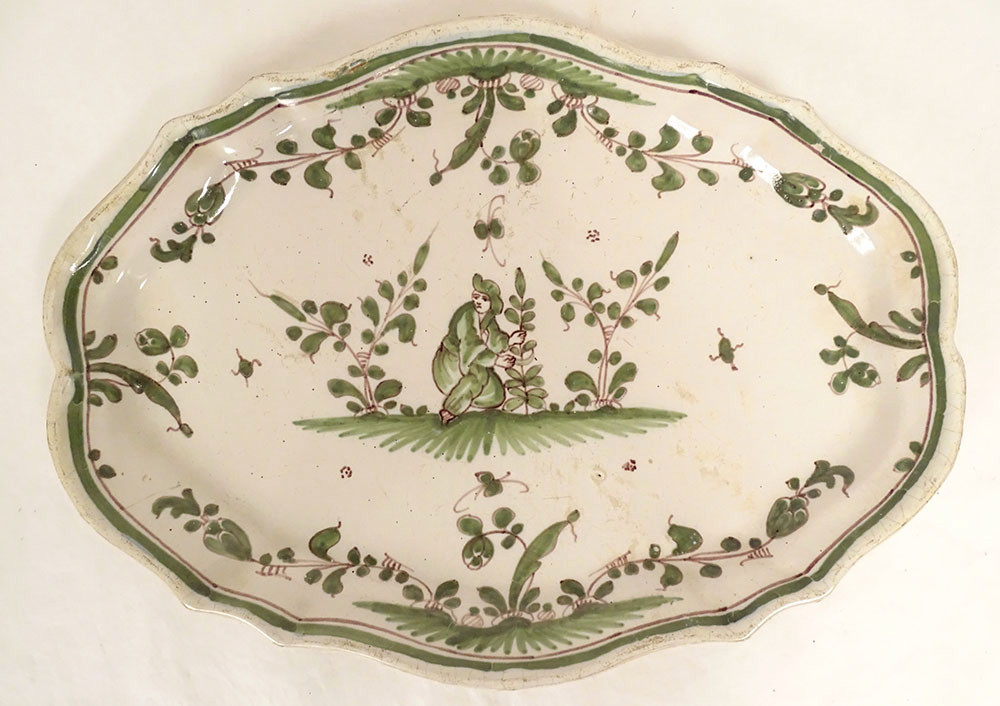 Oval Earthenware Dish From Moustiers With A Figure, Flowers, And Foliage, 18th Century