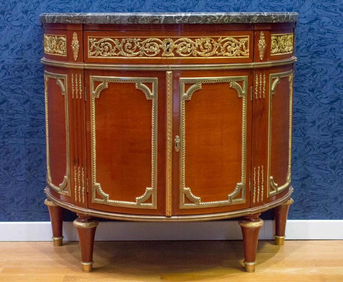 A Louis XVI Style Demi-lune Commode.