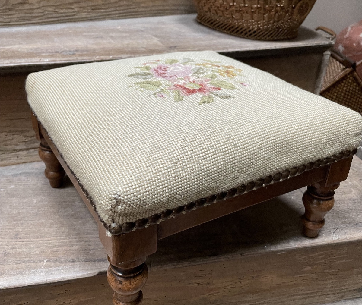 Repose pied recouvert d’une tapisserie au point 
