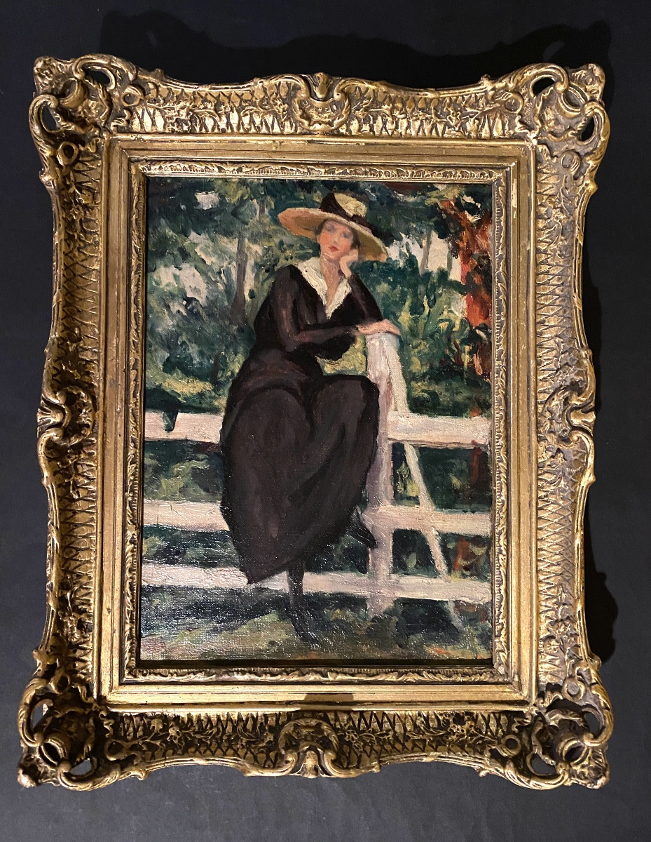 “Jeune femme au jardin”. Huile sur toile encadrée . Ecole française début XXème.