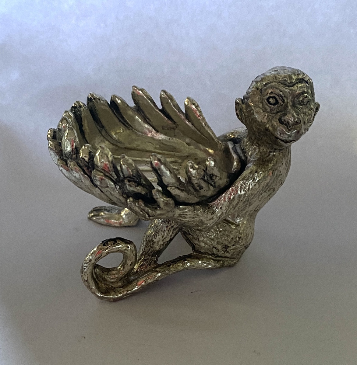 Salt Cellar In Silver Plated Metal. Seated Monkey Holding A Shell.
