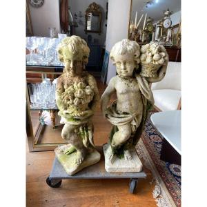 Pair Of Cherubs In Reconstructed Stone, Carrying A Basket Of Fruits.