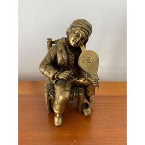 Bronze Newsboy Playing The Violin With A Bellows