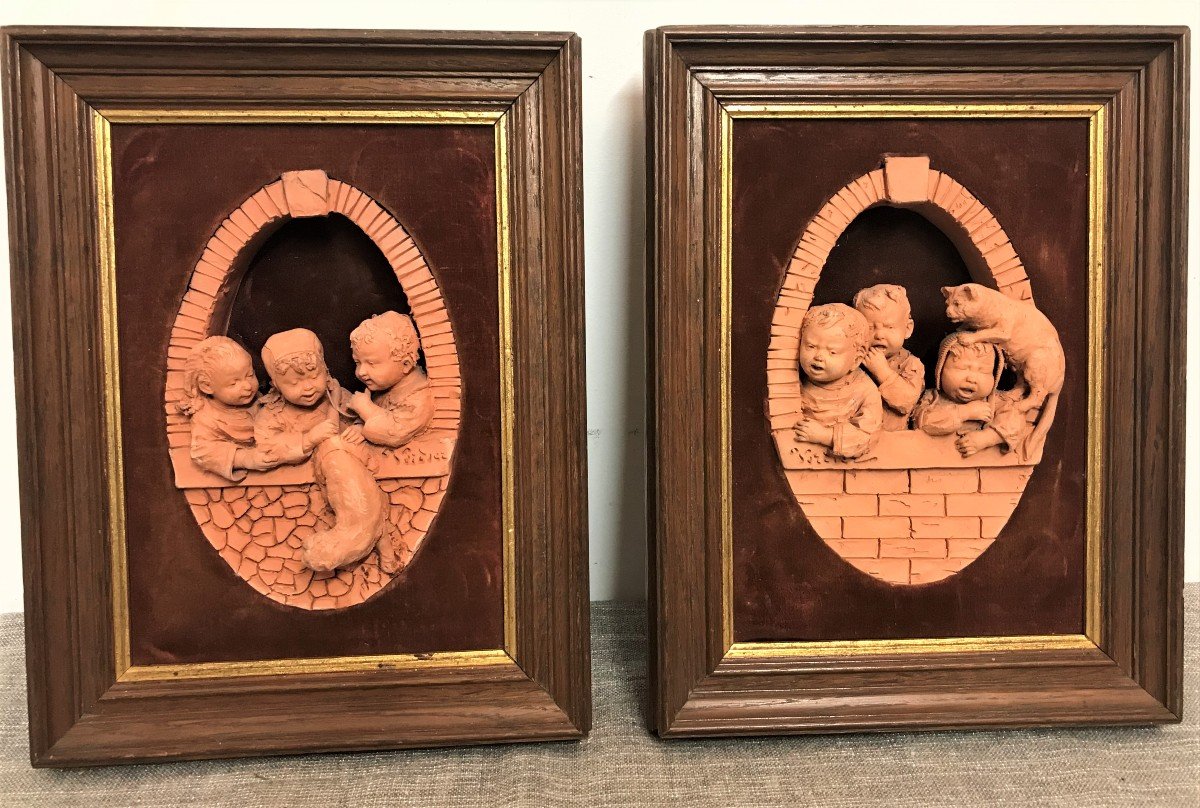 Two Framed Terracotta Sculptures Of Cats And Children, Early 20th Century