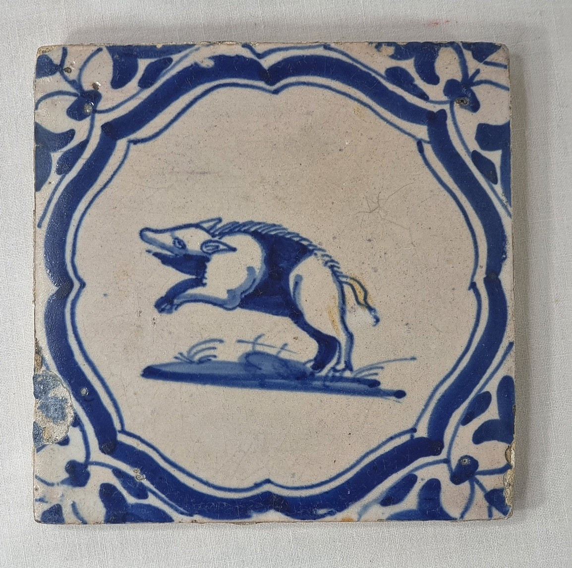 An Antique 17th-century Delft Tile Depicting A Leaping Boar In A Tenoned Frame