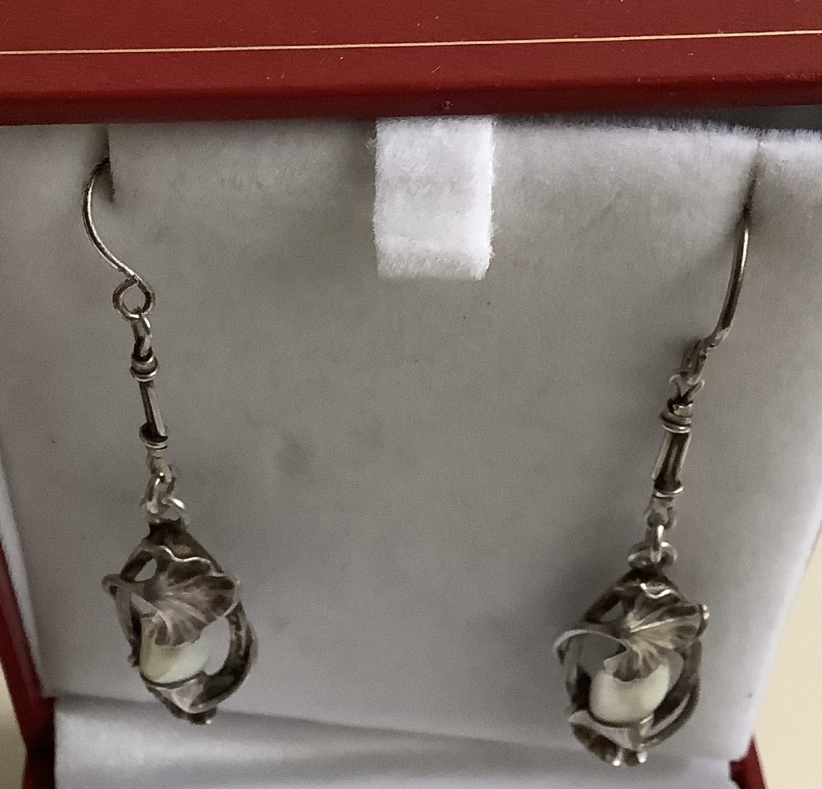 A Pair Of Silver Earrings By Paul Dumont, Featuring A Gingyo Design With A Pearl