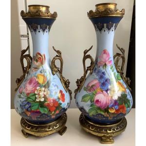 A Pair Of Porcelain Vases Decorated With Flowers And Characters