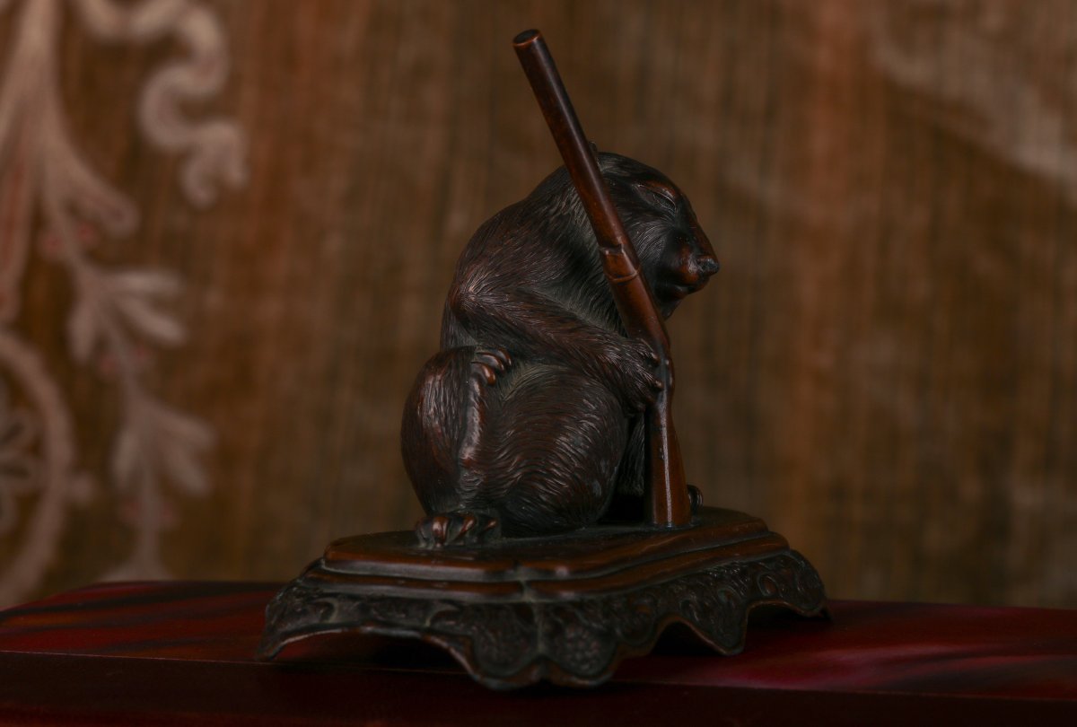 Small Animal Holding A Gun-photo-1