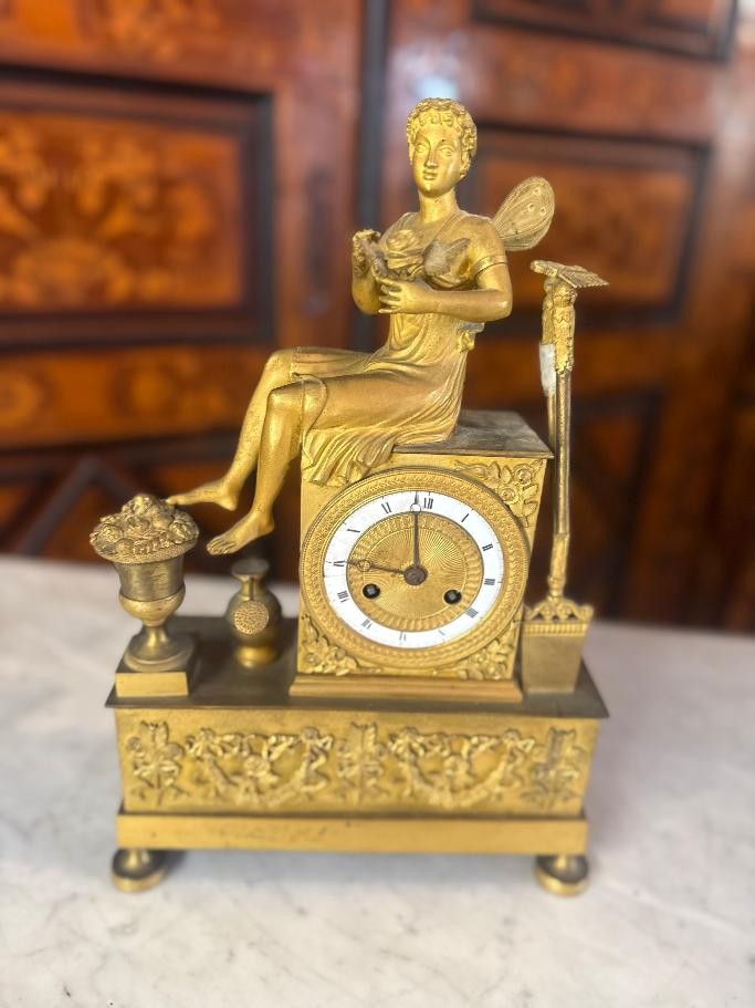 Clock From The Empire Period Decorated With An Antique Woman Allegorizing A Garden