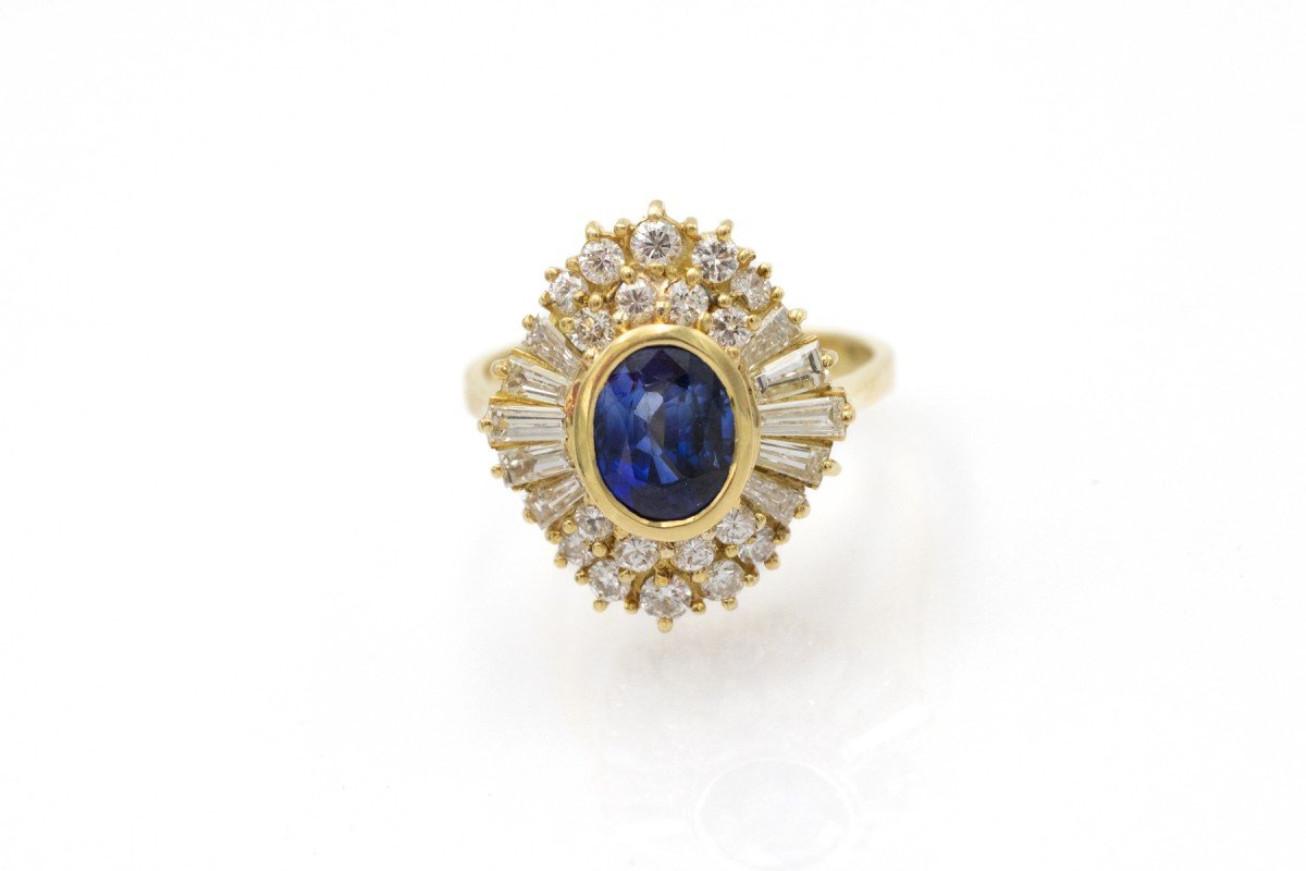 An 18-karat Gold Ring Set With A Natural Sapphire And Diamonds.