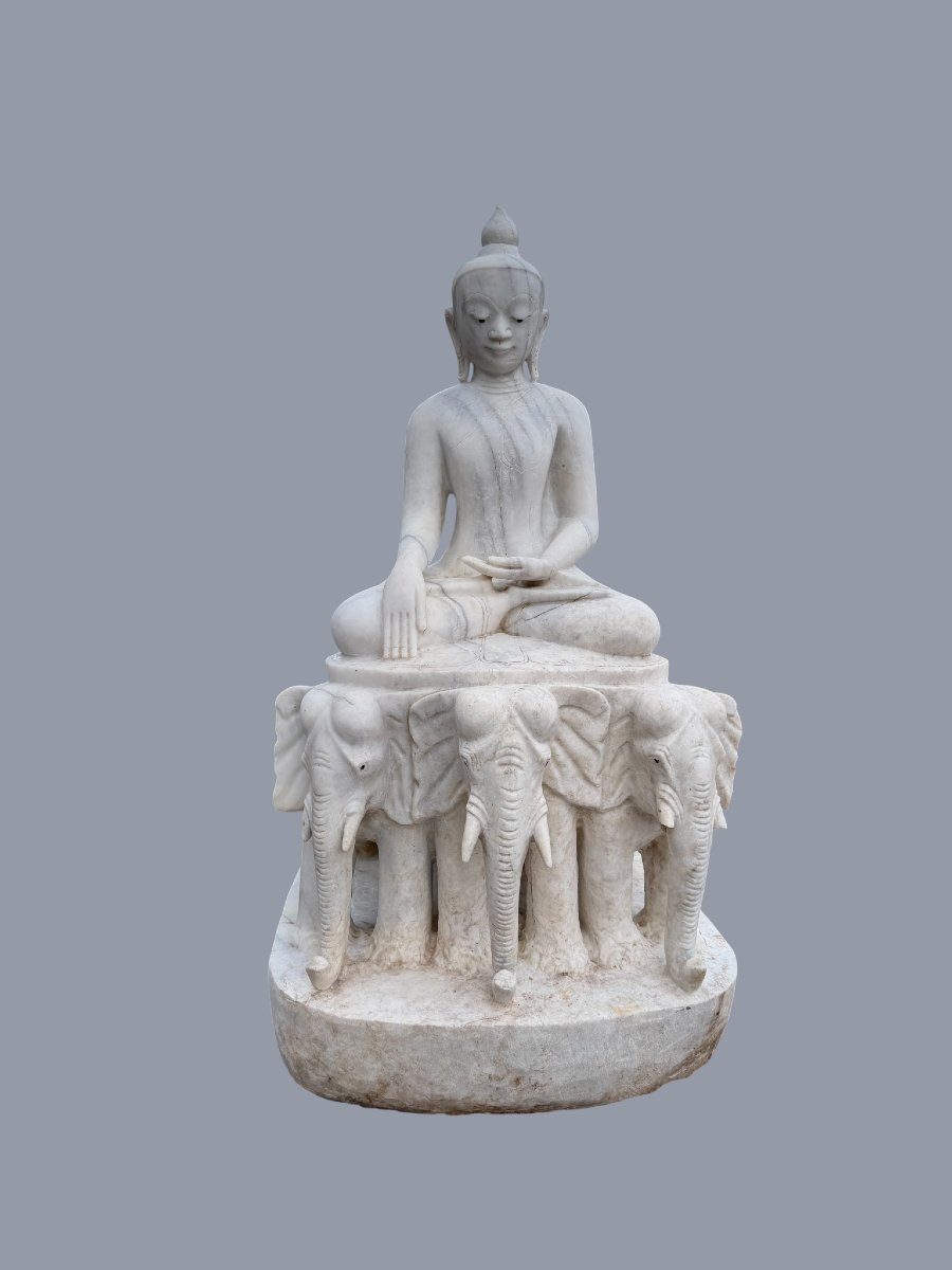 Marble Buddha Sculpture Seated On A Throne Of Elephants